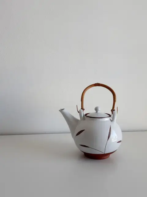The photo: ceramic teapot with a leaf pattern
